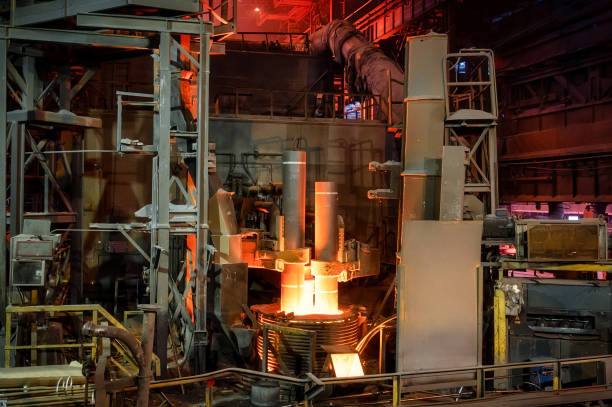 istock Electric arc steelmaking furnace, thick powerful red-hot graphite electrodes 1371499083