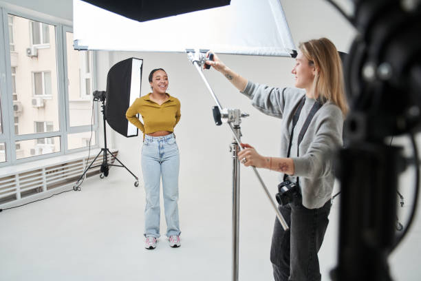 istock Female professional model smiling toothy while photographer putting soft box 1371500980