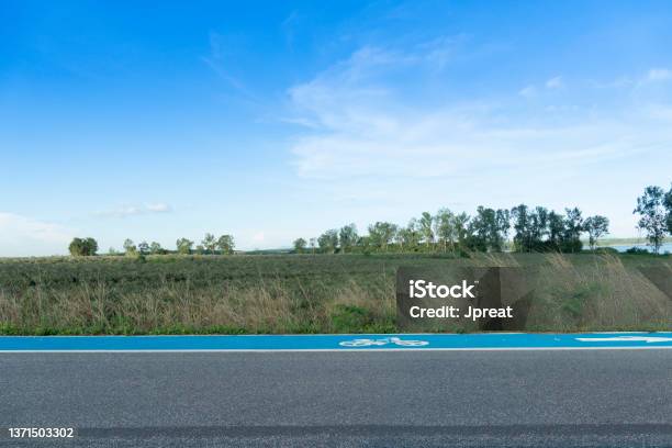 Horizontal And Landscape View Of Beside Asphalt Road With Bike Lens Blue Color Stock Photo - Download Image Now