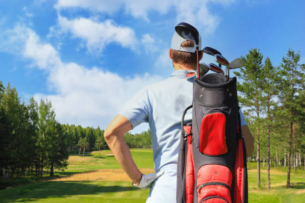 istock Golf player walking and carrying bag on course during summer game golfing. 1371504105