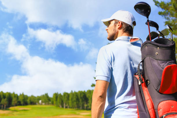 istock Golf player walking and carrying bag on course during summer game golfing. 1371504125
