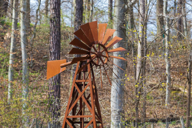 Old metal rusty pinwheel near the forest.