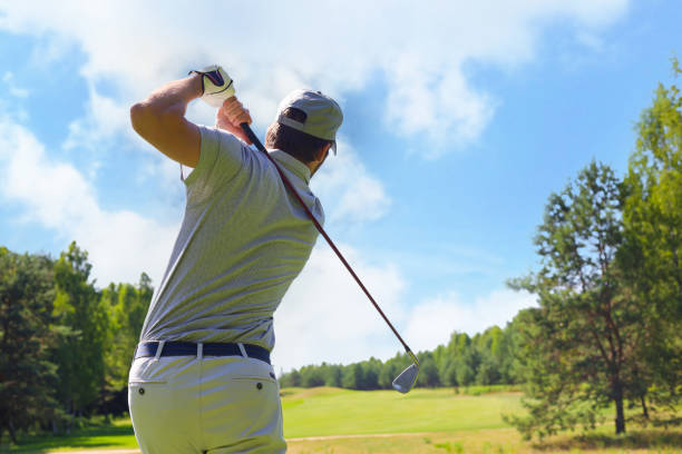 istock Golfer hitting golf shot with club on course while on summer vacation. 1371504492