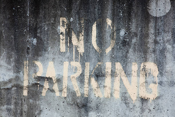 istock No Parking Sign spray painted onto dirty concrete wall 137150503