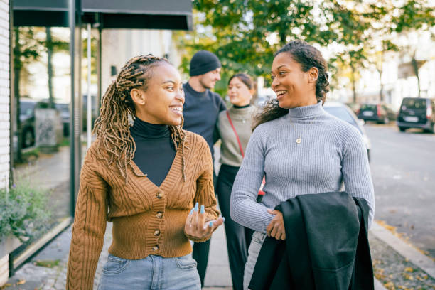 istock Women talking while walking in city. 1371510084