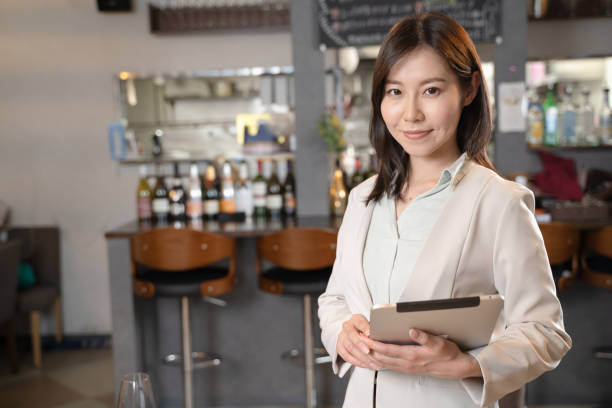 istock A woman who runs a restaurant with a tablet 1371516539