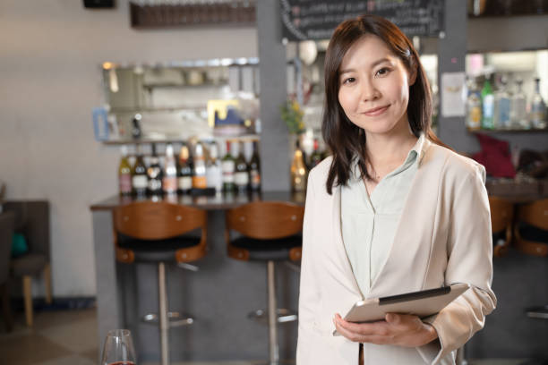 istock A woman who runs a restaurant with a tablet 1371516540