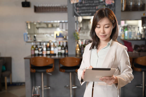 istock A woman who runs a restaurant with a tablet 1371516544