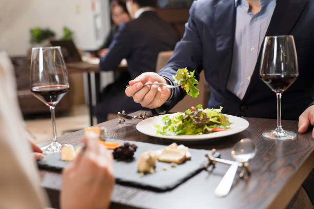 istock Men and women eating while having a conversation at a restaurant 1371516692