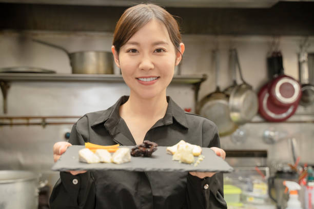 female staff serving food at the restaurant - salad japanese culture japan asian culture imagens e fotografias de stock