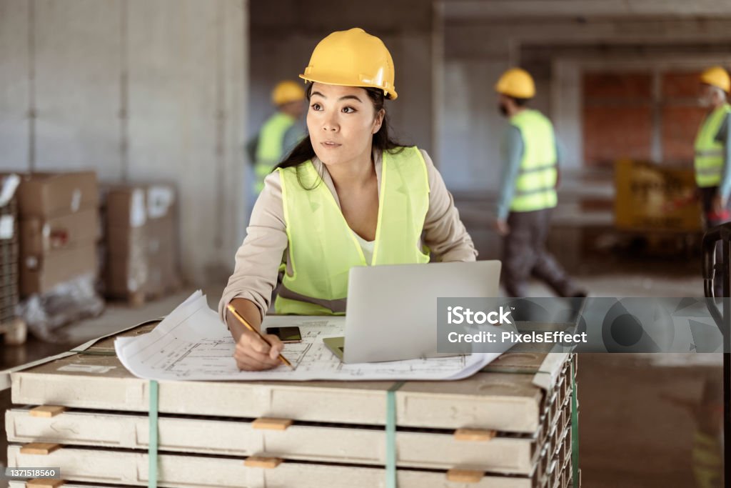 This is what she does best Young Confident Woman Working With Blue Print of the Building Under Construction Civil Engineer Stock Photo
