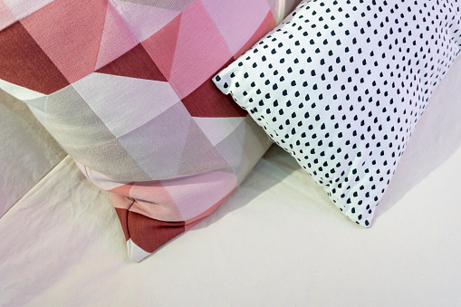 pink cushions on bed