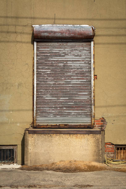 istock Shuttered door on abandoned industrial building. 1371520432