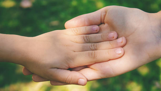 istock mom holding baby by the hand. selective focus 1371524730