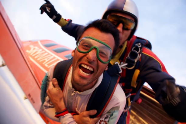 Skydiving tandem at the sunset stock photo
