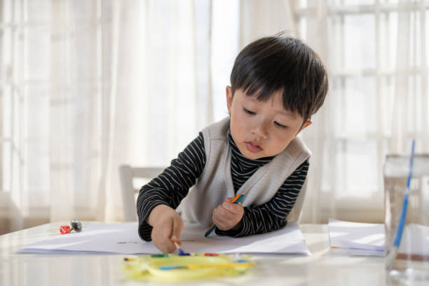 istock A little Asian boy drawing at the table 1371524982