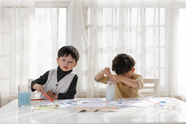 istock Two little Asian boys, drawing together 1371525049