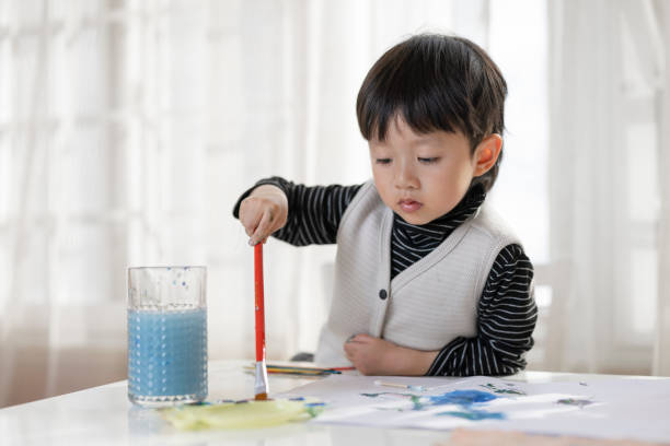 istock A little Asian boy drawing at the table 1371525051
