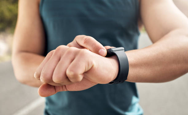 istock Shot of a man checking his watch while out for a run 1371525623