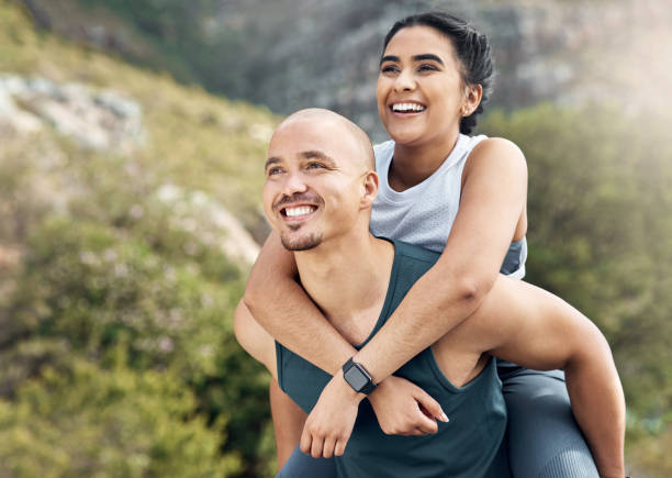 istock Shot of a man carrying his girlfriend on his back while out for a workout 1371525631