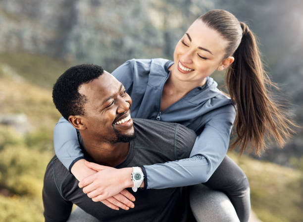 istock Shot of a man carrying his girlfriend on his back while out for a workout 1371525632