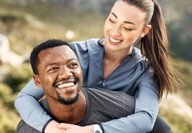 istock Shot of a man carrying his girlfriend on his back while out for a workout 1371525633