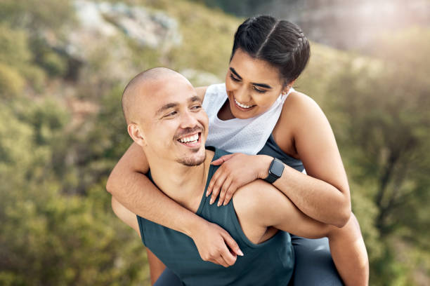 istock Shot of a man carrying his girlfriend on his back while out for a workout 1371525639
