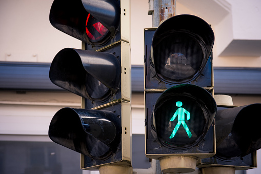 a traffic light with pedestrian signs in a city in germany