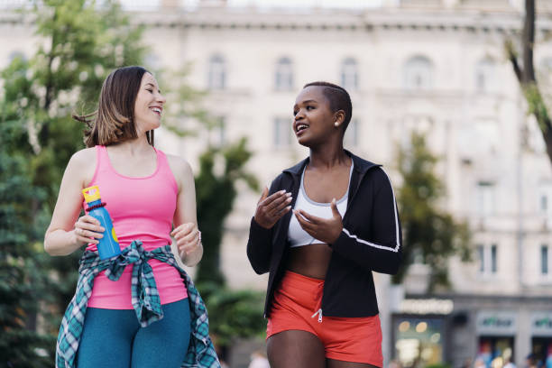 istock Two multiethnic girls walking for a exercise session, outdoor communicating. 1371526498
