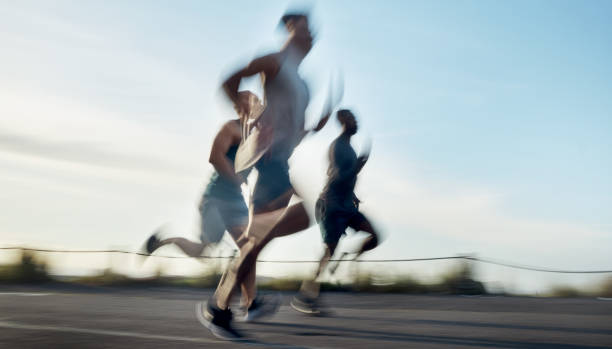 istock Blurred shot of three athletic young men running together 1371526700