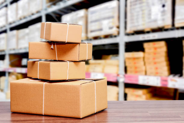Stack of cardboard boxes on warehouse background stock photo