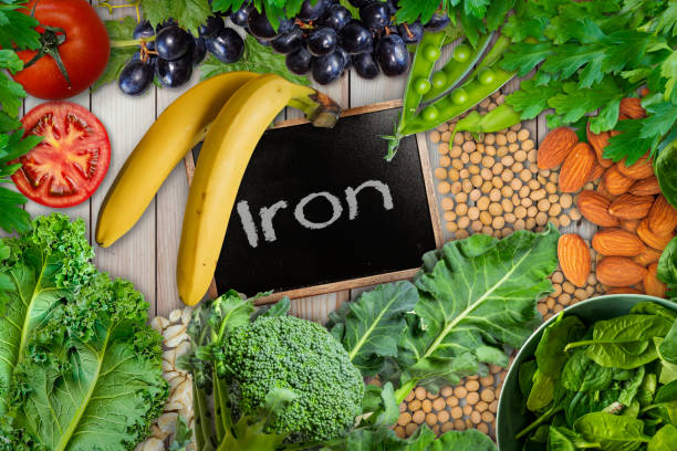Plant based sources of iron background. broccoli, banana, tomatoes, almond, spinach, green peas, collards, grapes, kale, soya been and nuts are iron-rich foods. Plant based sources of iron background. broccoli, banana, tomatoes, almond, spinach, green peas, collards, grapes, kale, soya been and nuts are iron-rich foods. iron-rich foods stock pictures, royalty-free photos & images