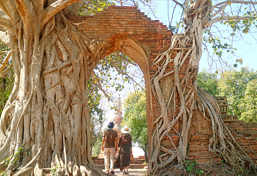 Couple Entering the Gate of Wat Phra Ngam Temple Ruins Also Known As GATE OF TIME, Archaeological Site in Ayutthaya, Thailand, ( Self Portrait )