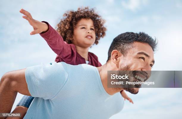 Shot Of A Man Spending Time At The Beach With His Son Stock Photo - Download Image Now