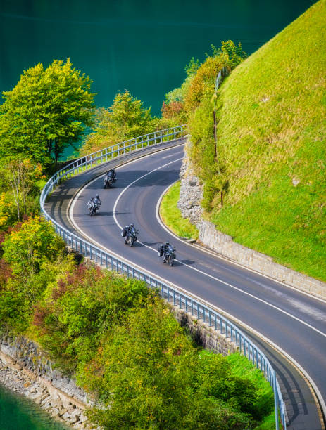 A team of motorcyclists travels the beautiful roads in the summer. The road and the turns. Traveling on a motorcycle. Recreation and active life. A team of motorcyclists travels the beautiful roads in the summer. The road and the turns. Traveling on a motorcycle. Recreation and active life. 4 wheel motorbike stock pictures, royalty-free photos & images