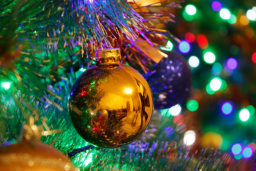 bright multi-colored decoration balls on the Christmas tree indoor closeup