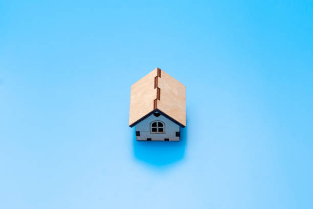 istock small wooden house on a blue background 1371534689