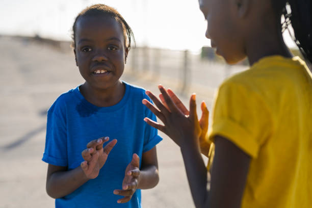 Several children in Kigali, Rwanda proudly displaying just how high they could reach.