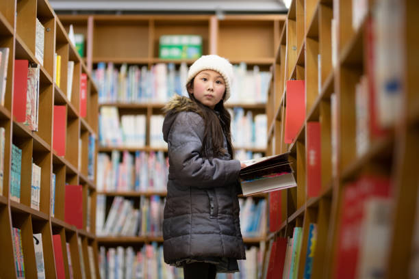 istock Girl choosing a book 1371537559
