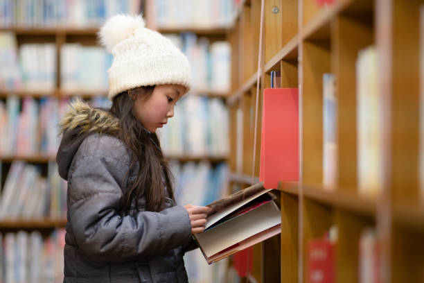 istock Girl choosing a book 1371537561