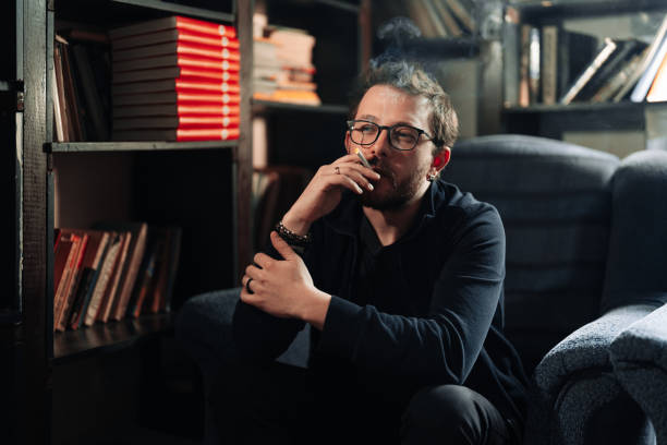 istock Smoking Man portrait with books in background 1371537733