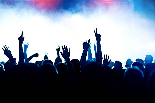 istock Concert crowd silhouetted by stage lights and smoke 137153916