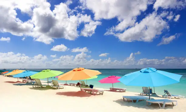 Sandy beach with colorful umbrellas in Sint Marteen