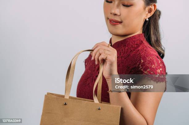 Happy Young Beautiful Asian Woman Wearing Red Oriental Cheongsam Dress With Luxury Accessories Such As Golden Ring And Bracelet With White Background Stock Photo - Download Image Now