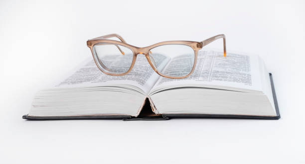 istock Glasses at open book. Education concept. Bible, dictionary reading. 1371545805