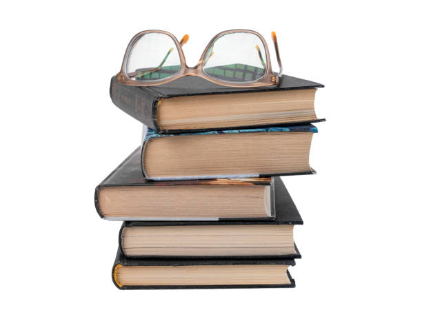 istock Books stack with eyeglasses isolated on white background. Education and reading leisure concept. 1371546806