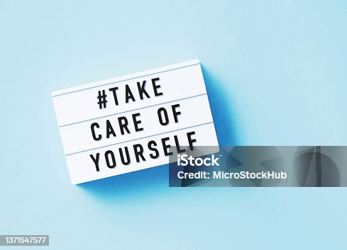 istock Take Care Of Yourself Written White Lightbox Sitting On Blue Background 1371547577