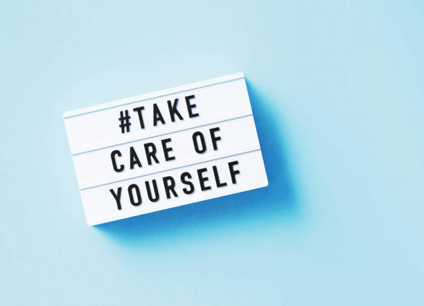Take Care Of Yourself Written White Lightbox Sitting On Blue Background Take care of yourself written white lightbox sitting on blue background. Horizontal composition with copy space. low key stock pictures, royalty-free photos & images