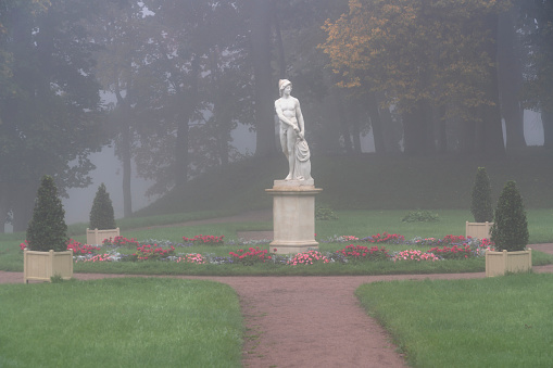Statue of Young Mars in the Lower Dutch Garden of Gatchina Park on an autumn foggy morning, Gatchina, St. Petersburg, Russia