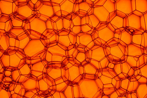 Macro of structures in water soap bubble in orange color